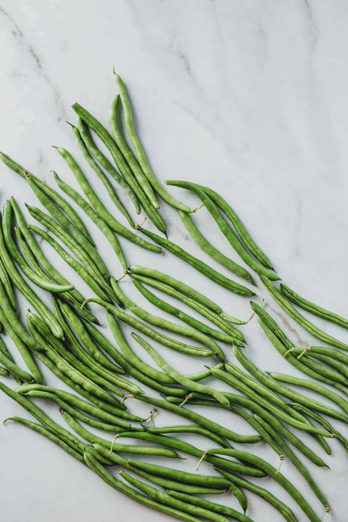 Green beans on a marble background